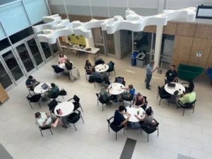 A group of people seated at tables in an atrium